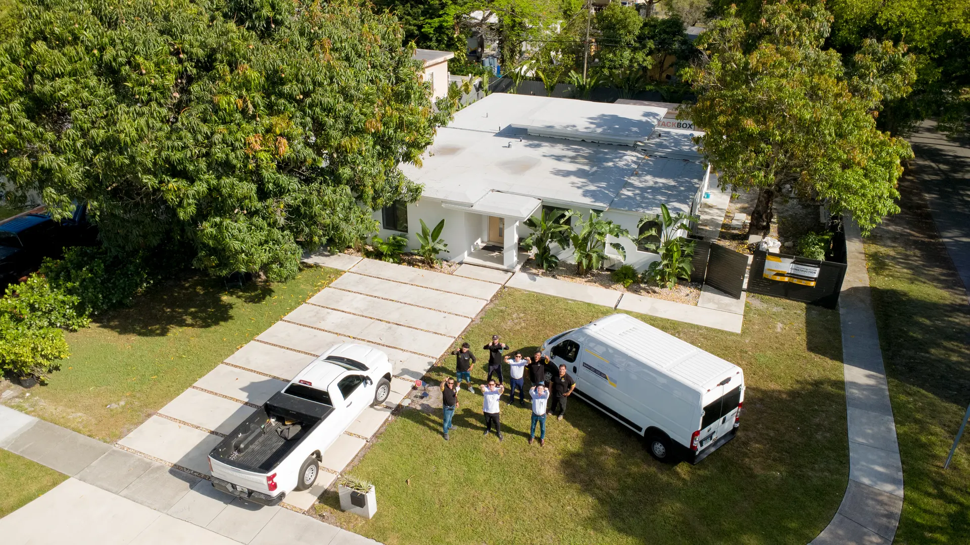 Aerial view of a completed Customized Builders renovation with the project team on site